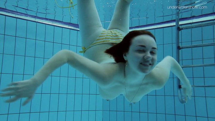 Naked girl swimming underwater lake