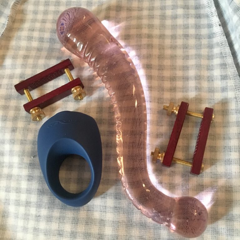 Toys with glass dildo while
